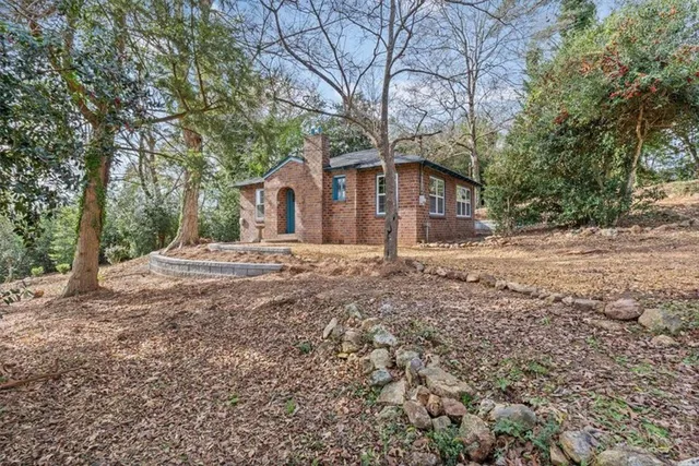 a large kitchen with stainless steel appliances and white cabinets