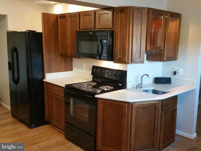 4807 Woods Wharf Road Shady Side, MD 20764 - Photo 6 of 12 a kitchen with stainless steel appliances granite countertop a refrigerator stove and microwave