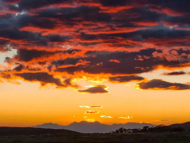 a kitchen with a dining table chairs sink and cabinets