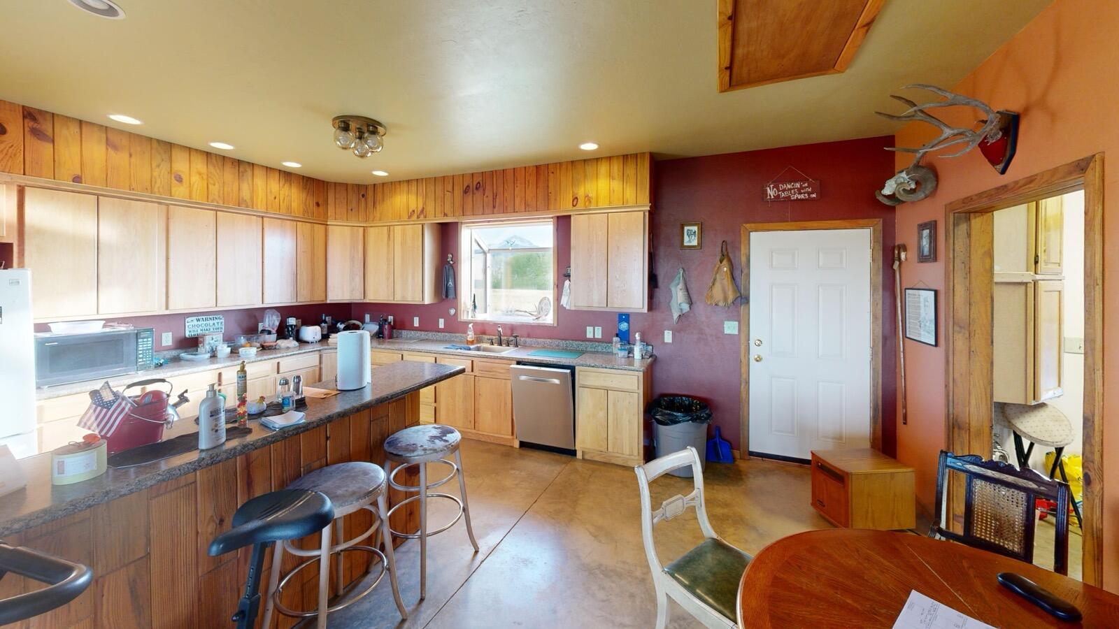 8325 County Rd M44 Placerville, CO 81430 - Photo 40 of 62 a kitchen with a dining table chairs sink and cabinets