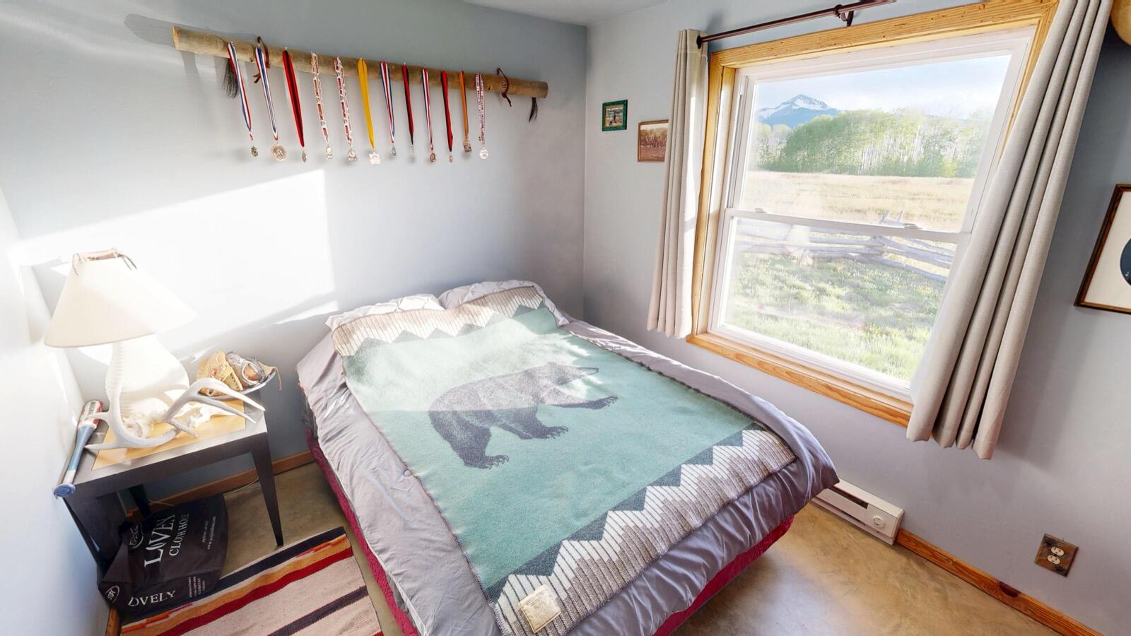 8325 County Rd M44 Placerville, CO 81430 - Photo 44 of 62 a bedroom with a bed and a flat tv screen