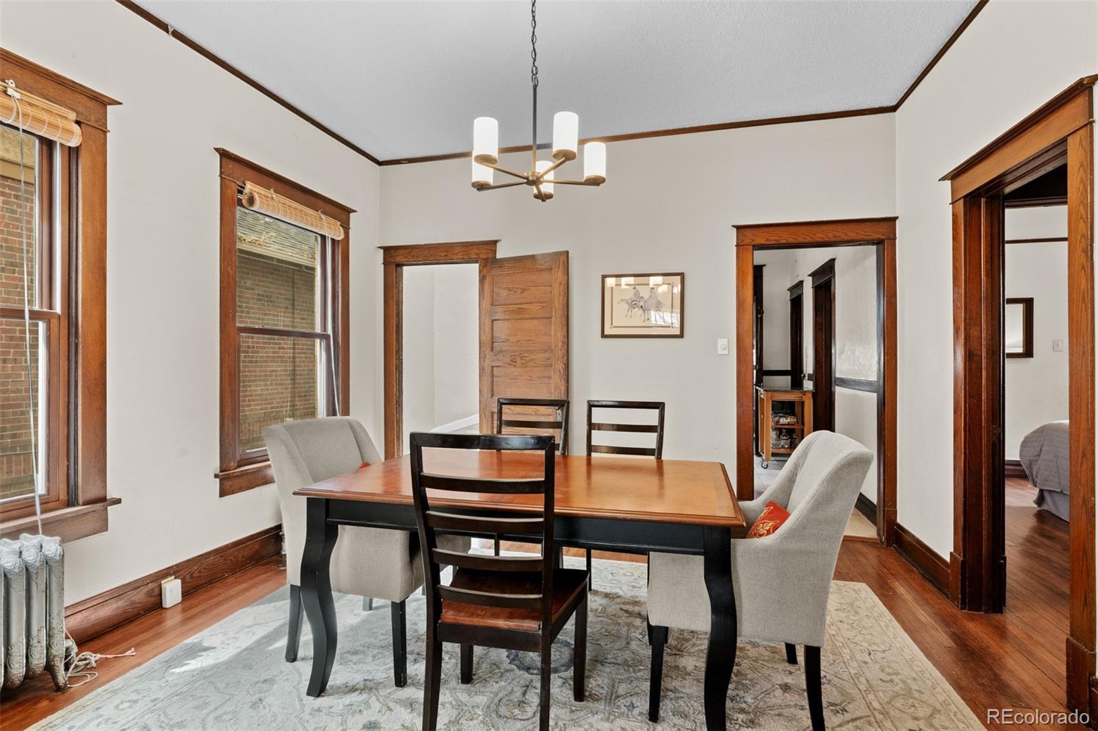 3517 York Street Denver, CO 80205 - Photo 11 of 45 a dining room with furniture window and wooden floor