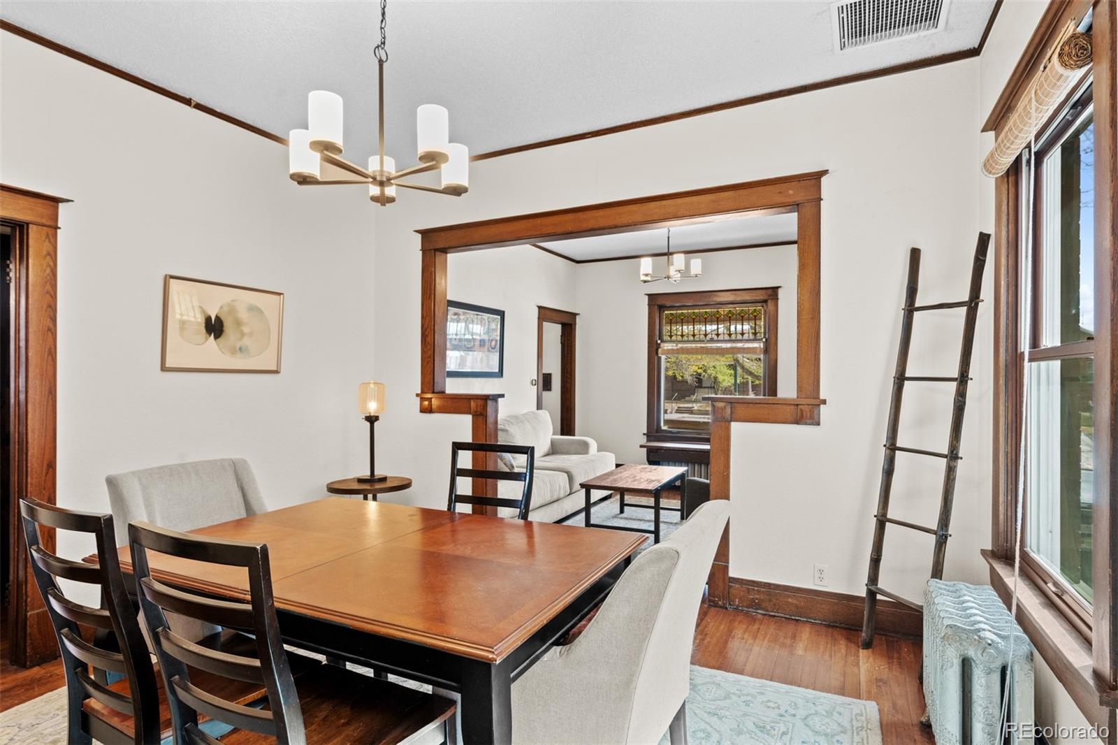 3517 York Street Denver, CO 80205 - Photo 13 of 45 a view of a dining room with furniture window and wooden floor