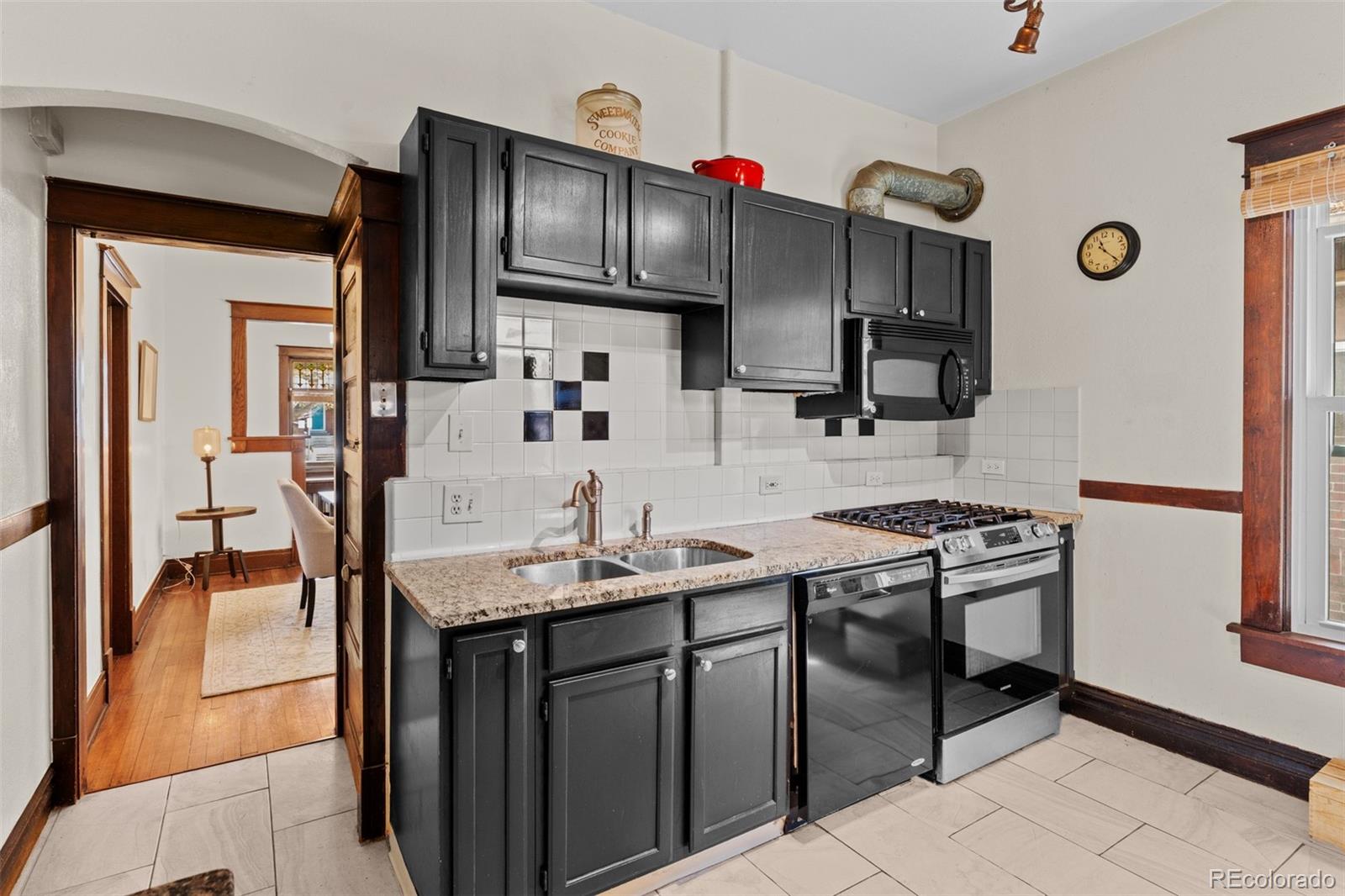 3517 York Street Denver, CO 80205 - Photo 16 of 45 a kitchen with stainless steel appliances granite countertop a sink stove and refrigerator