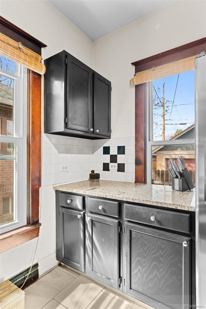 3517 York Street Denver, CO 80205 - Photo 17 of 45 a kitchen with a sink cabinets and a window