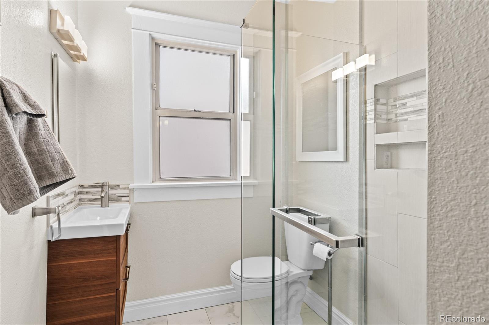3517 York Street Denver, CO 80205 - Photo 24 of 45 a bathroom with a bathtub and a shower