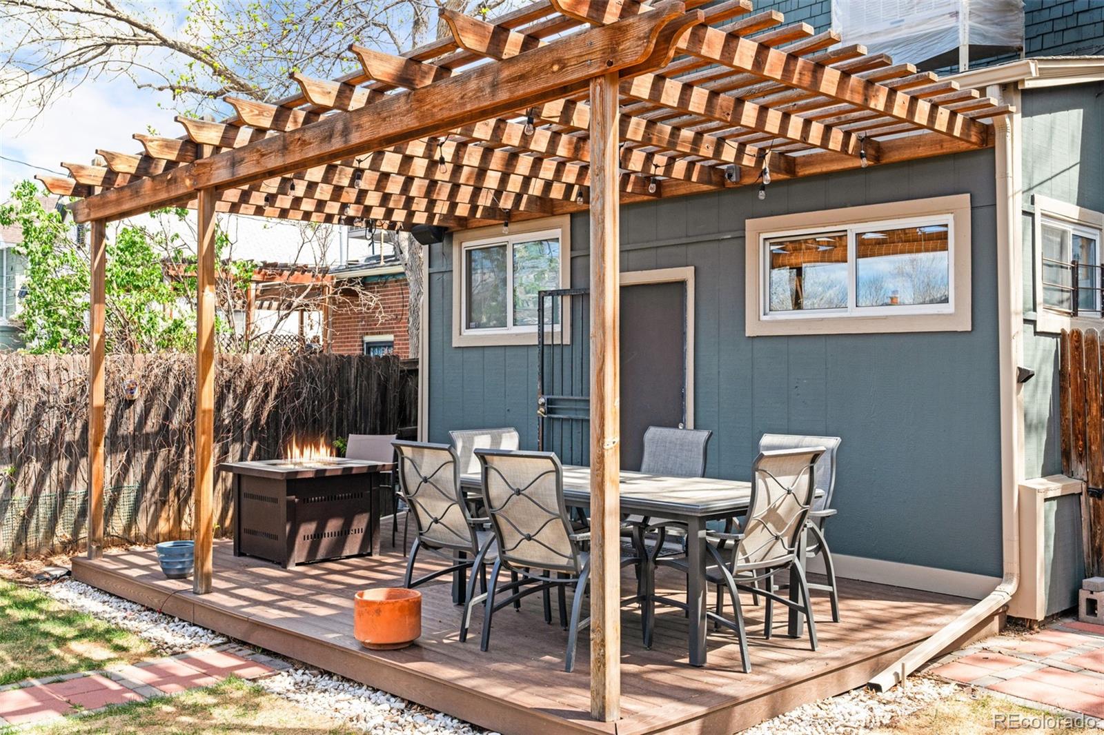 3517 York Street Denver, CO 80205 - Photo 40 of 45 a view of a patio with table and chairs with wooden floor and fence