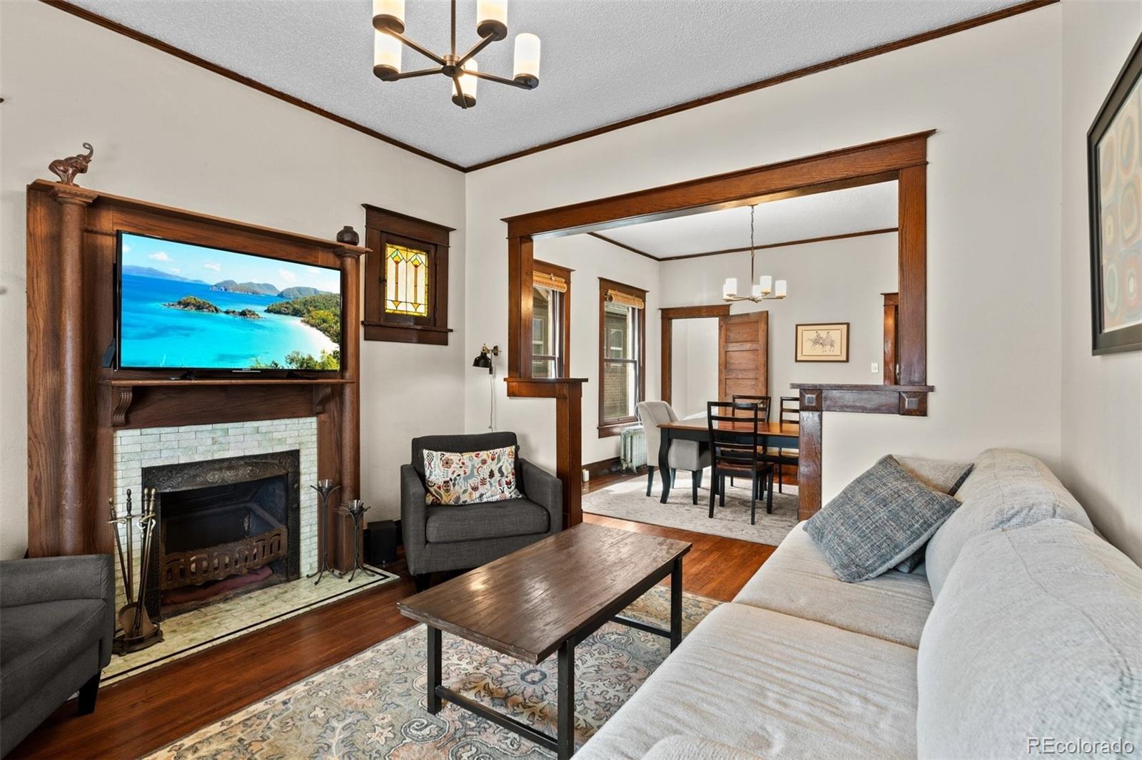 3517 York Street Denver, CO 80205 - Photo 6 of 45 a living room with furniture a flat screen tv and a fireplace