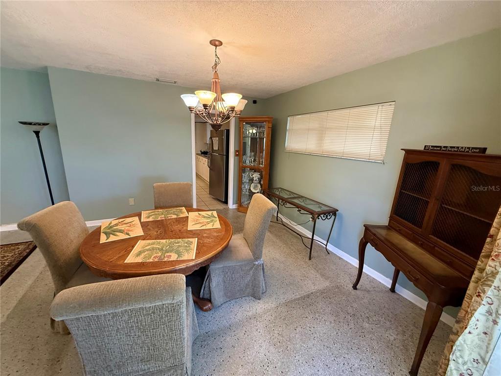1004 Connecticut Road Tarpon Springs, FL 34689 - Photo 12 of 57 a dining room with furniture and wooden floor