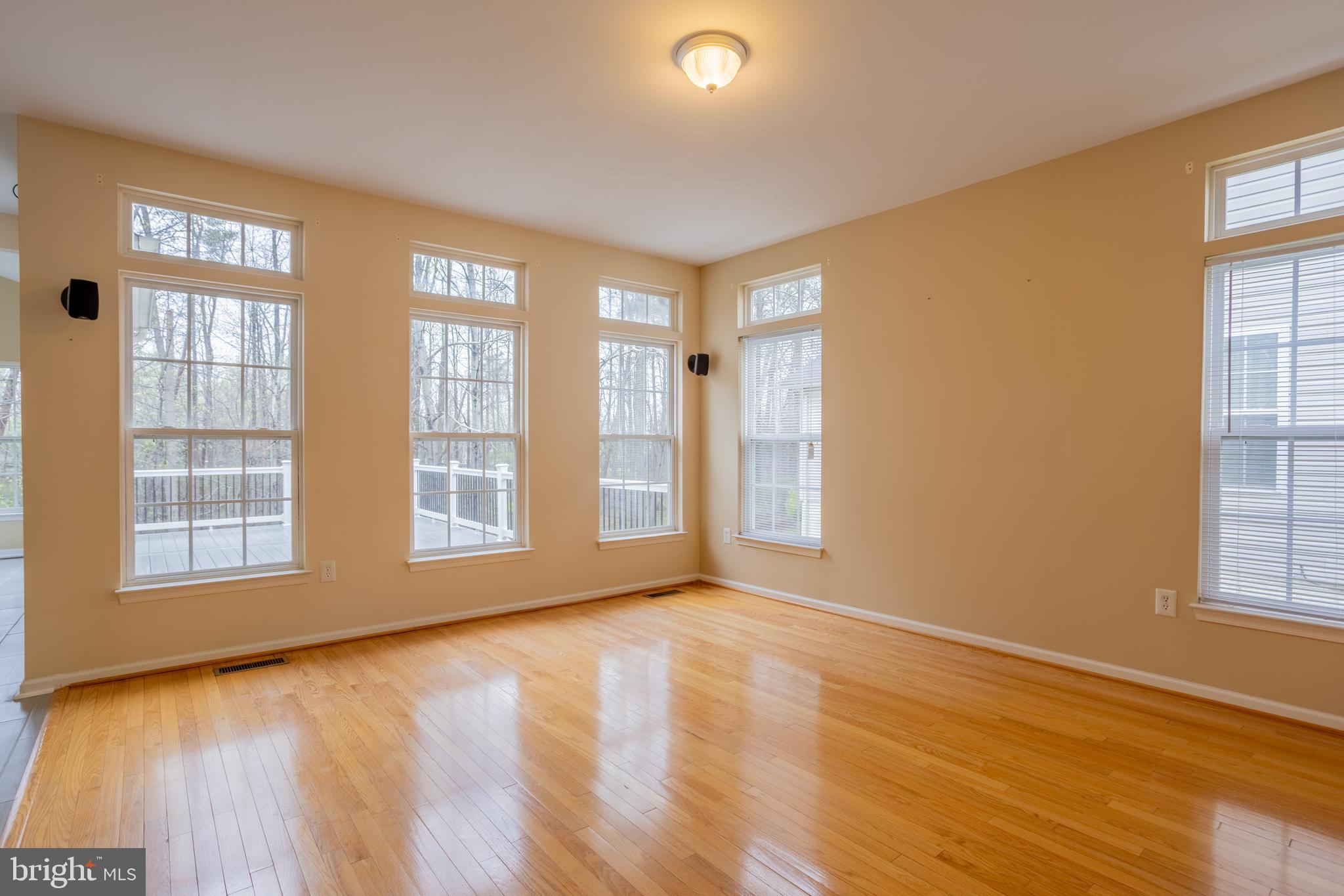7740 Rotherham Drive Hanover, MD 21076 - Photo 11 of 62 a view of an empty room with a window and wooden floor
