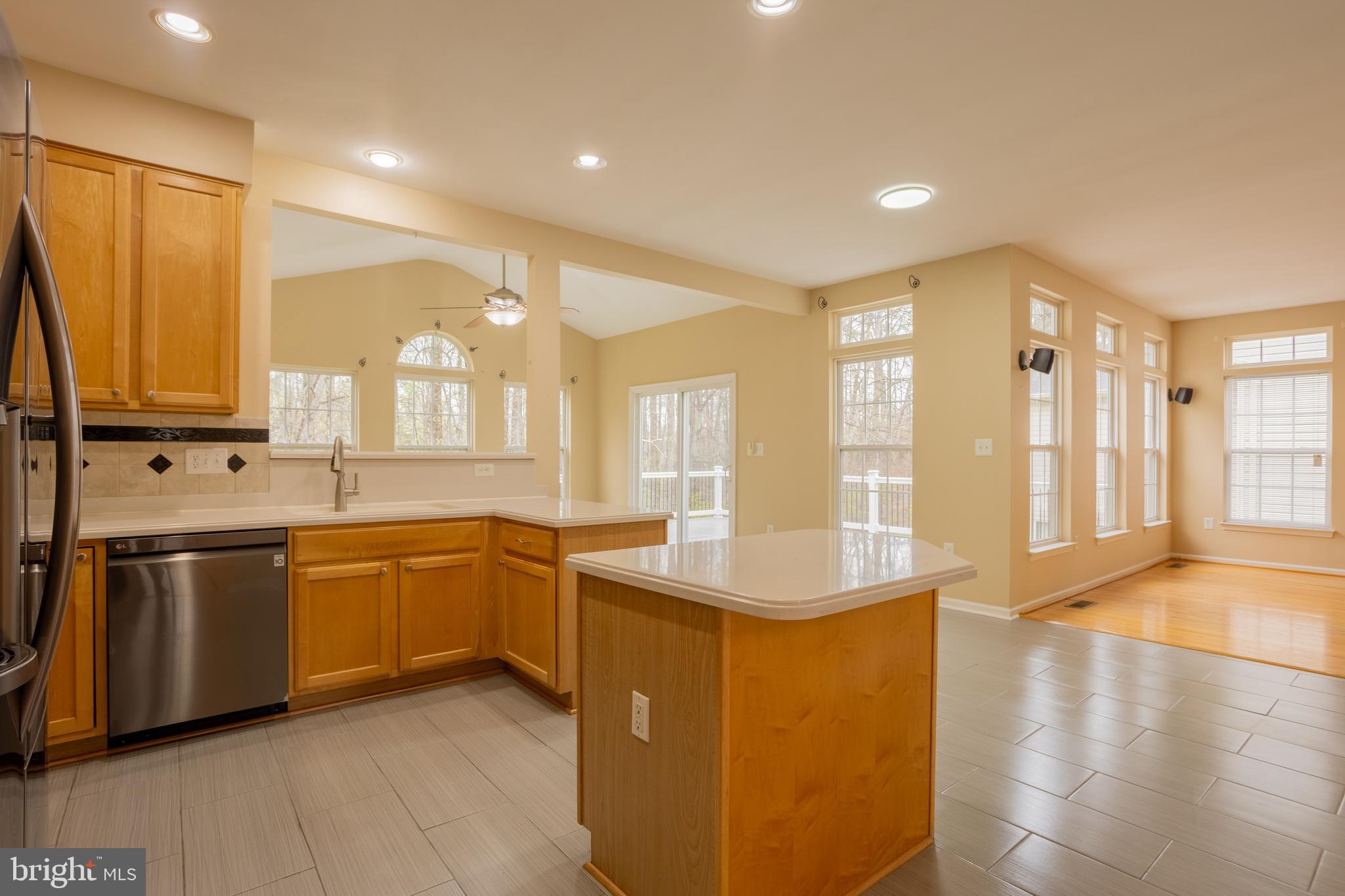 7740 Rotherham Drive Hanover, MD 21076 - Photo 14 of 62 a large kitchen with stainless steel appliances a large window a sink and a counter top space