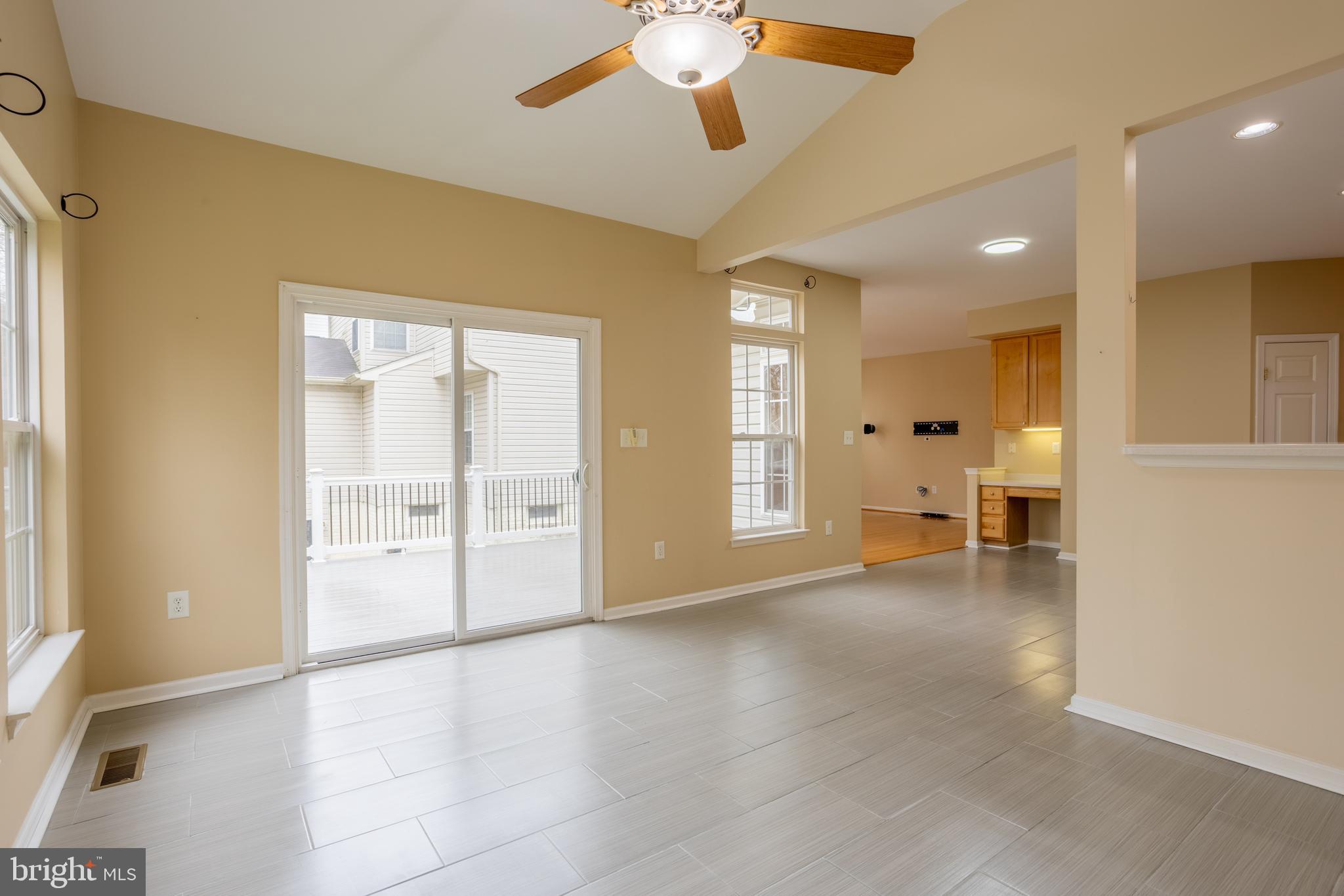 7740 Rotherham Drive Hanover, MD 21076 - Photo 17 of 62 a view of an empty room with wooden floor and a window