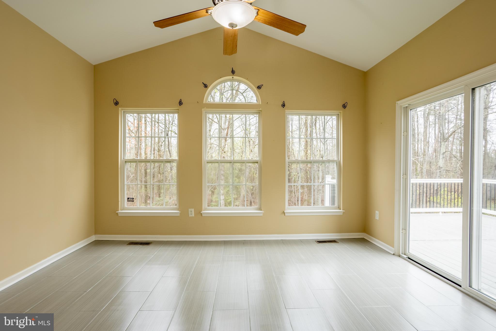 7740 Rotherham Drive Hanover, MD 21076 - Photo 18 of 62 a view of an empty room with a window and wooden floor