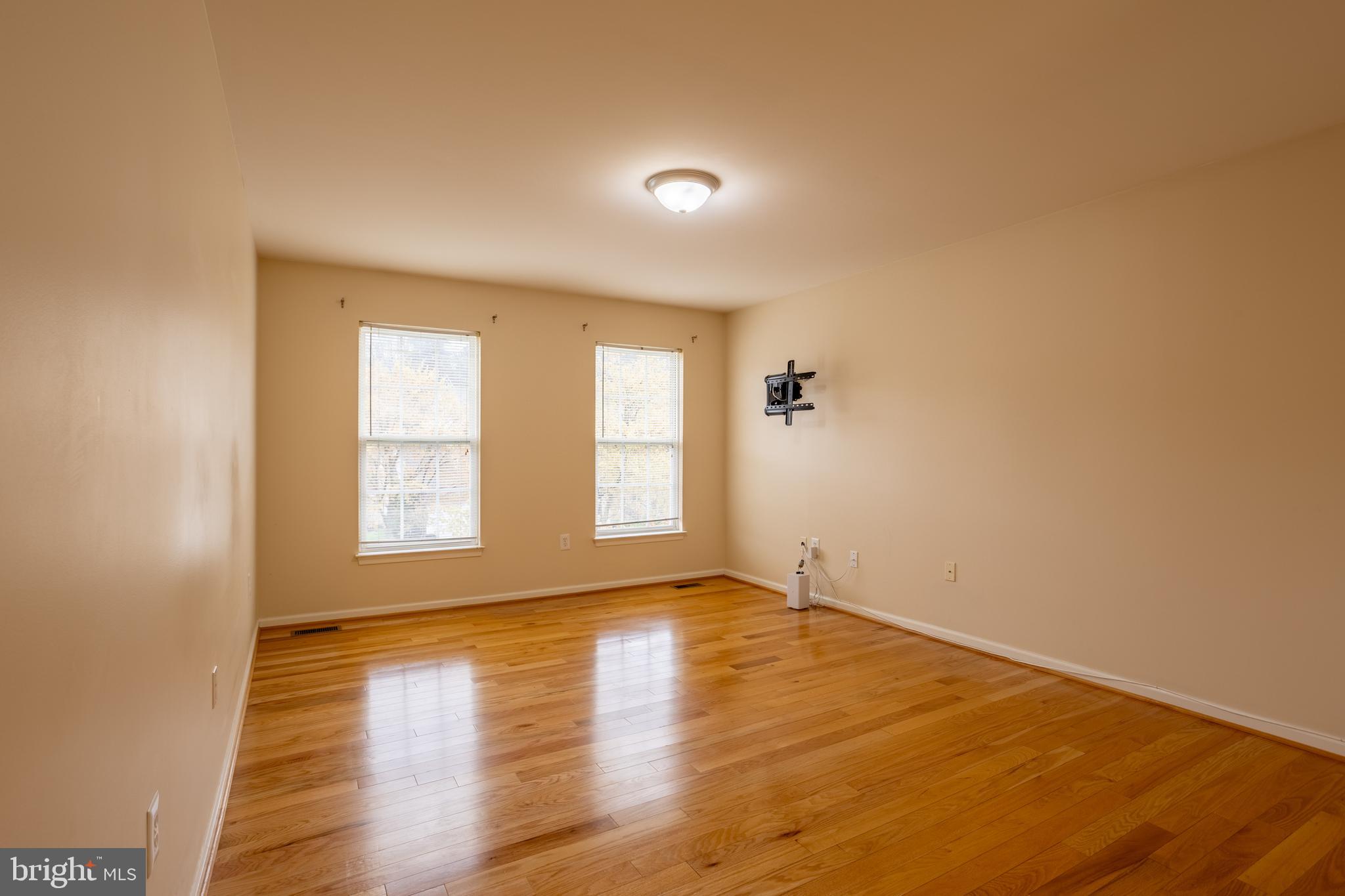 7740 Rotherham Drive Hanover, MD 21076 - Photo 27 of 62 an empty room with wooden floor and windows