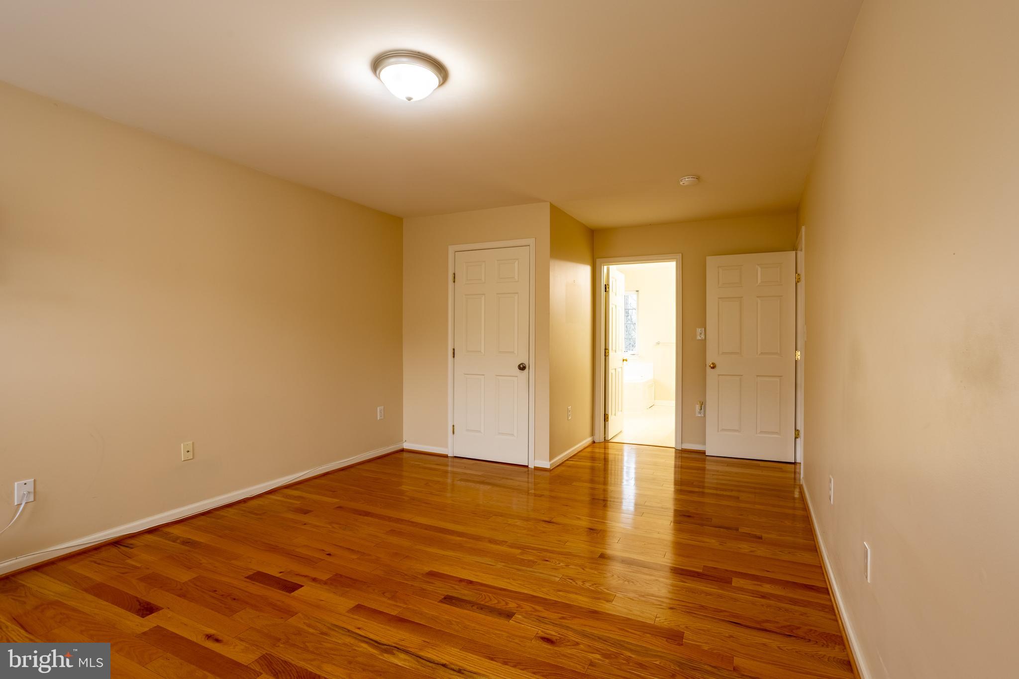 7740 Rotherham Drive Hanover, MD 21076 - Photo 28 of 62 a view of an empty room with wooden floor and a window