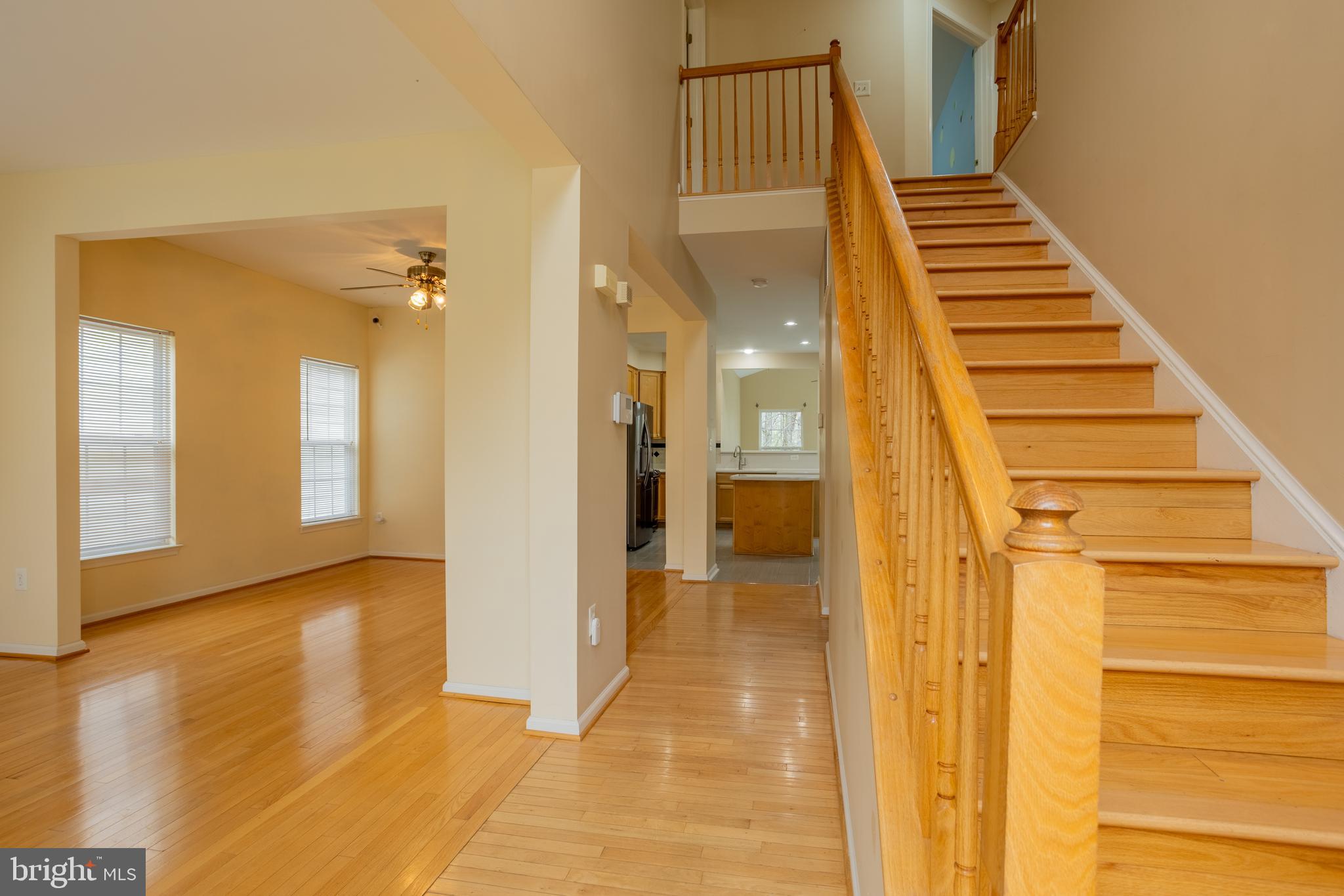 7740 Rotherham Drive Hanover, MD 21076 - Photo 3 of 62 a view of a hallway with wooden floor and staircase