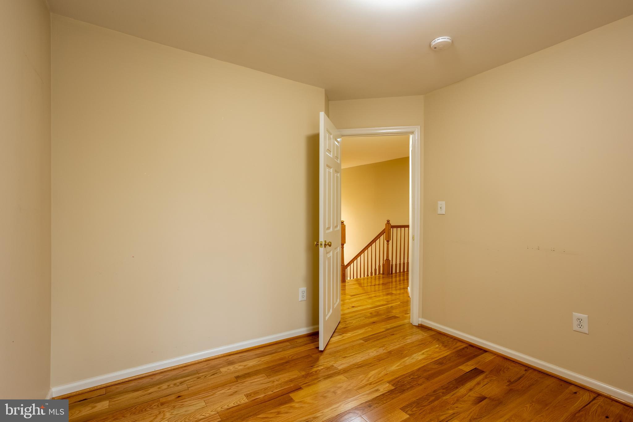 7740 Rotherham Drive Hanover, MD 21076 - Photo 36 of 62 an empty room with wooden floor and a window
