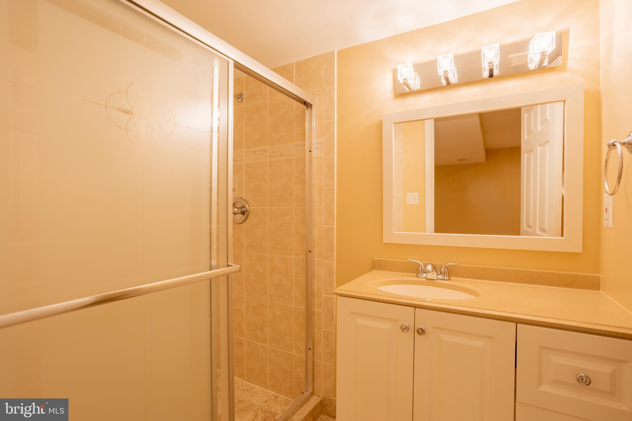 7740 Rotherham Drive Hanover, MD 21076 - Photo 51 of 62 a bathroom with a sink and a mirror