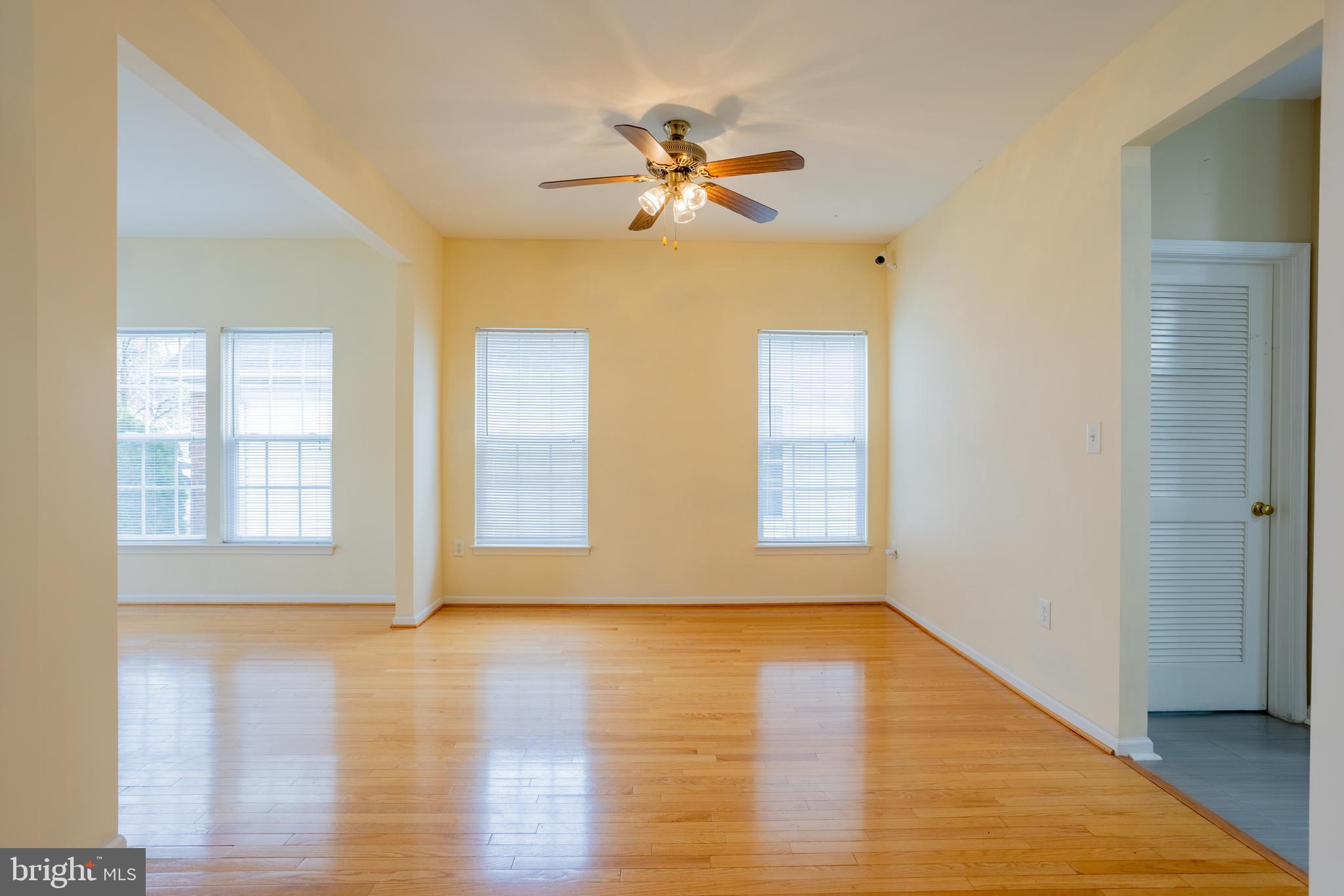 7740 Rotherham Drive Hanover, MD 21076 - Photo 8 of 62 a view of an empty room with wooden floor and a window
