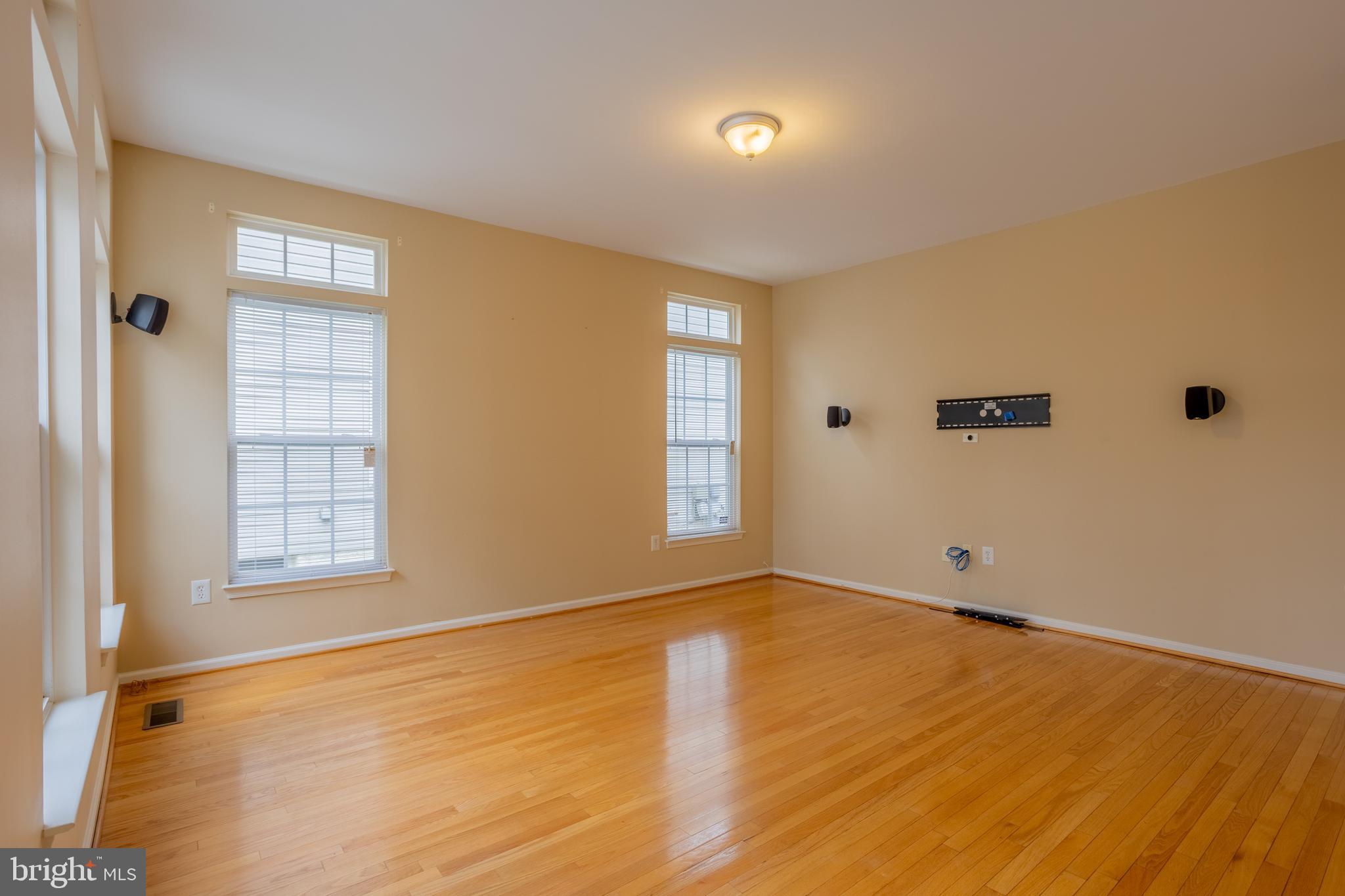 7740 Rotherham Drive Hanover, MD 21076 - Photo 10 of 62 a view of an empty room with wooden floor and a window