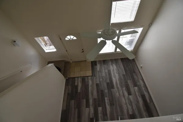 a view of staircase with wooden floor and a window
