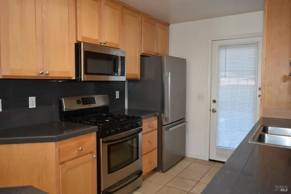 a kitchen with stainless steel appliances a refrigerator stove and microwave