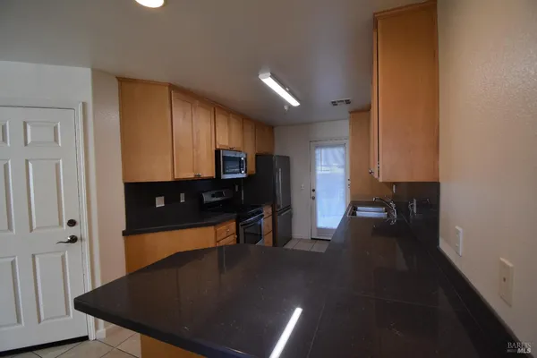 a view of a kitchen with a sink cabinets and a window