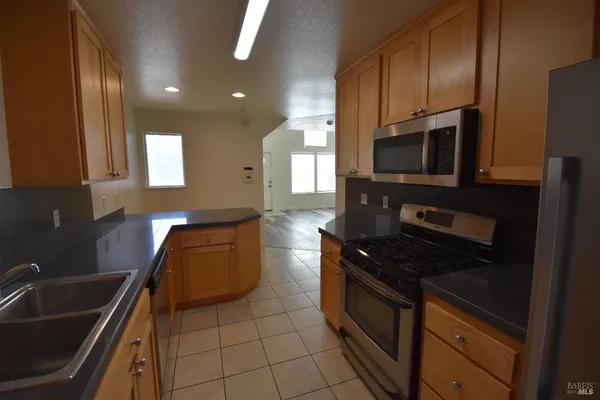 a kitchen with stainless steel appliances a sink stove and microwave