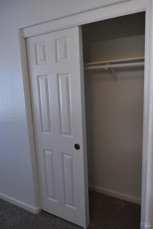 an empty room with closet area