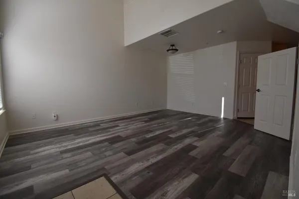 a view of a room with wooden floor