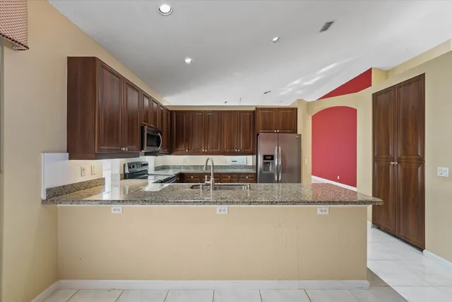 a view of a hallway with wooden floor and a glass door