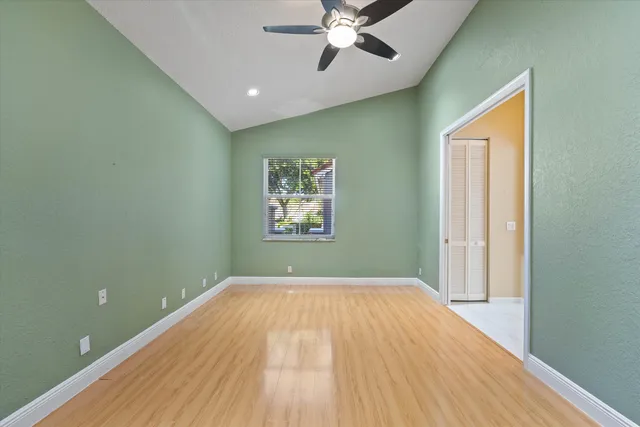 an aerial view of residential houses with outdoor space and trees