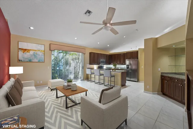 a kitchen with stainless steel appliances granite countertop a refrigerator a stove a sink and a microwave