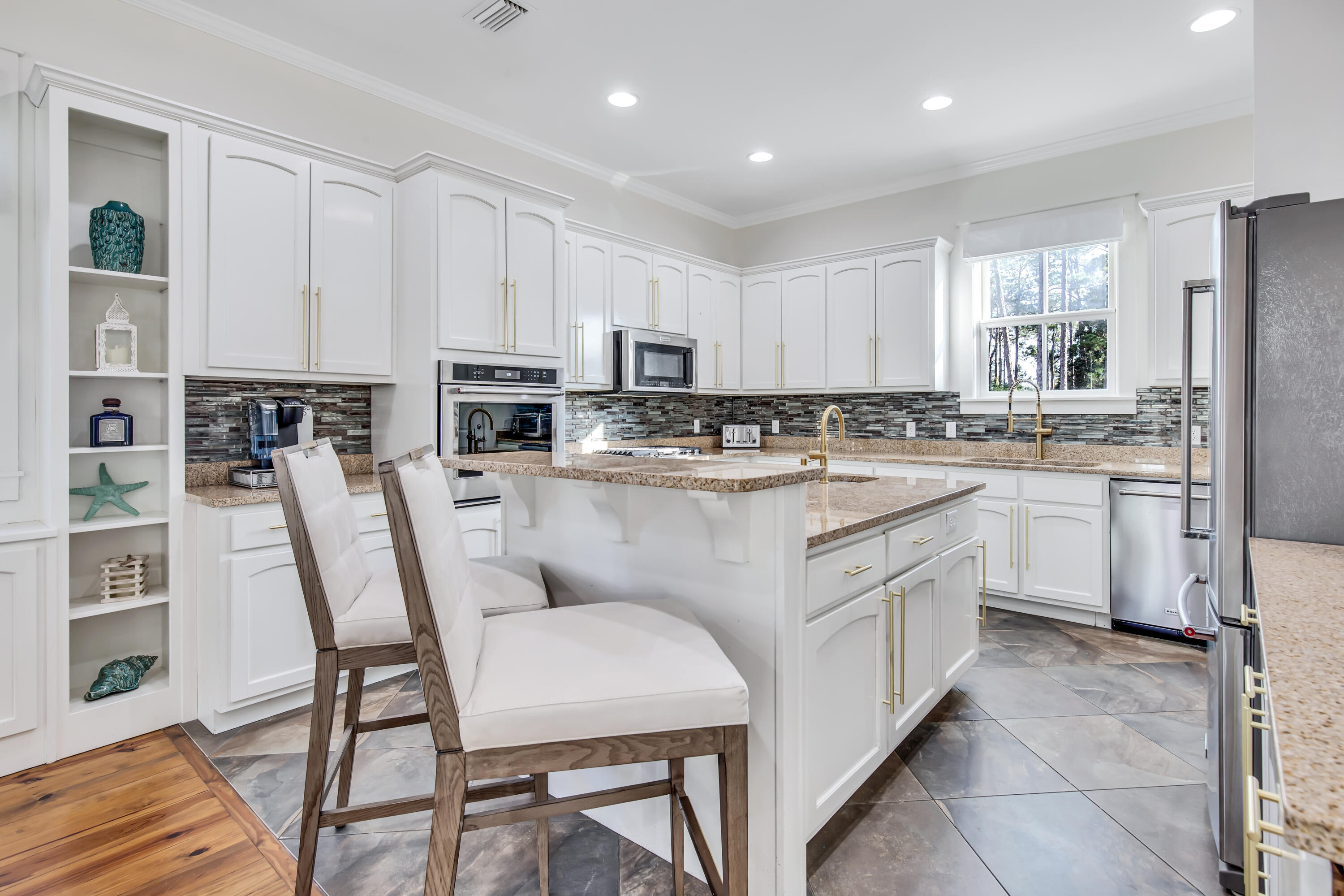 195 Redbud Lane Inlet Beach, FL 32461 - Photo 11 of 24 a kitchen with stainless steel appliances granite countertop a table chairs sink refrigerator and cabinets