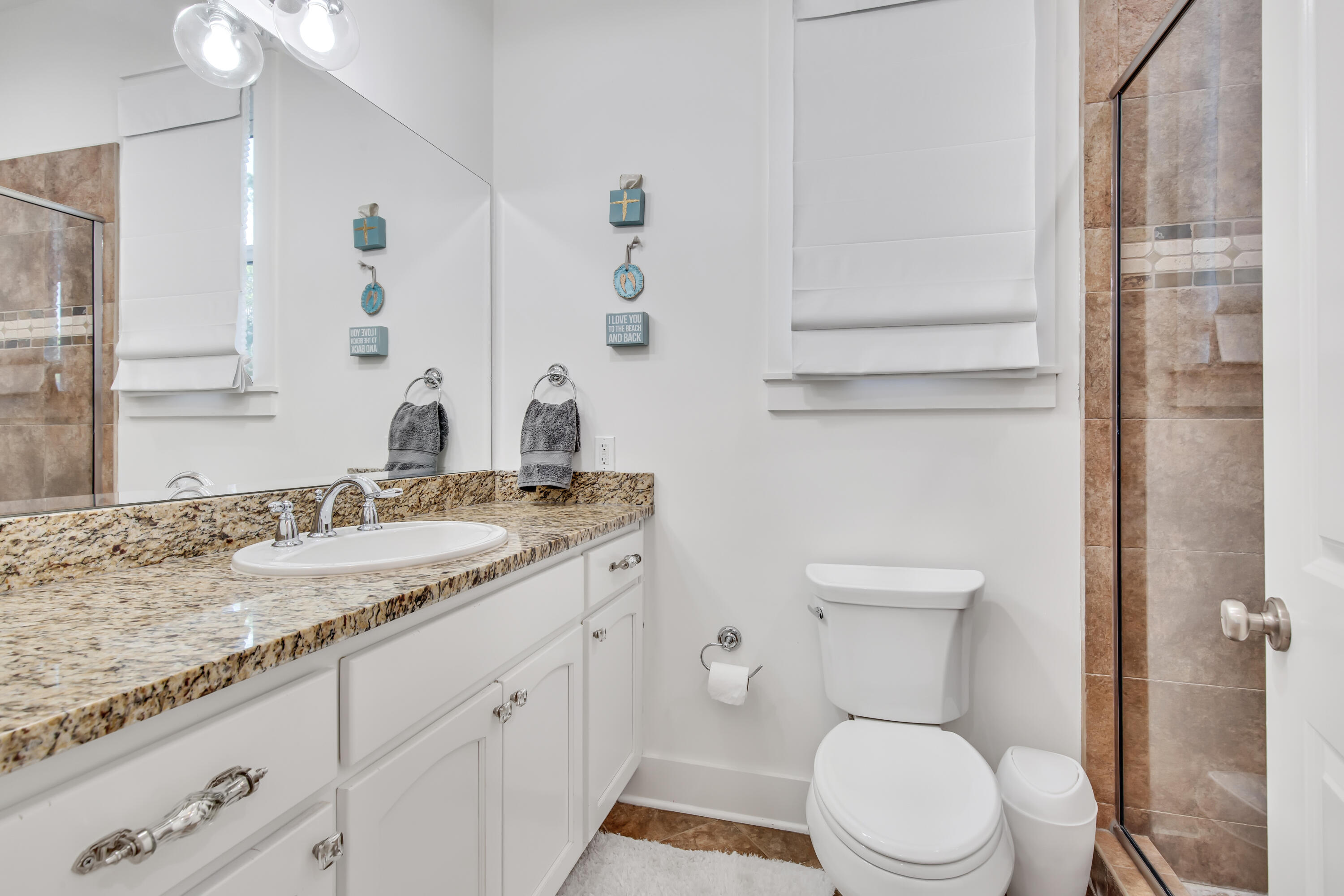 195 Redbud Lane Inlet Beach, FL 32461 - Photo 6 of 24 a bathroom with a granite countertop toilet sink and mirror