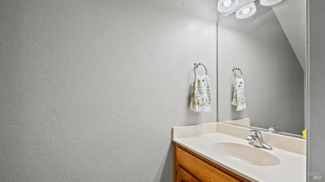 a bathroom with a sink vanity and a mirror