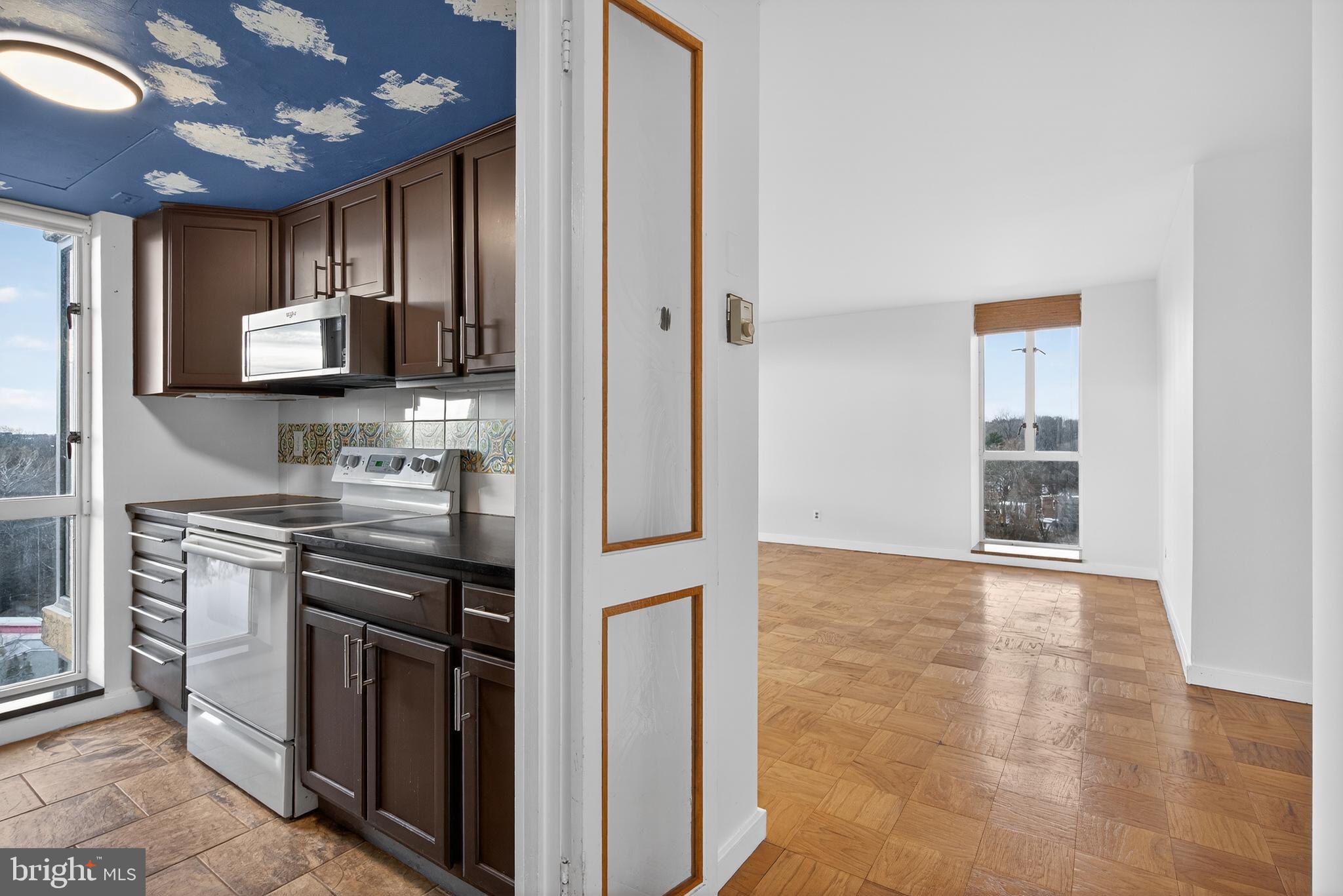 11400 Washington Plaza West, Unit 1303 Reston, VA 20190 - Photo 13 of 34 a kitchen with stainless steel appliances granite countertop a stove and a refrigerator