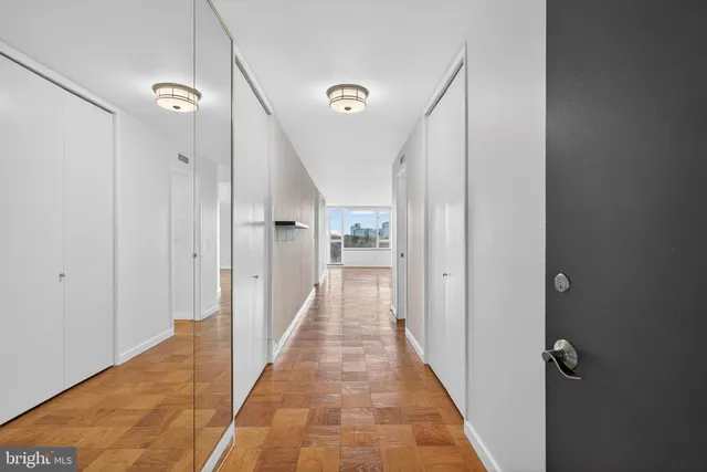 a view of a room with wooden floor and cabinet