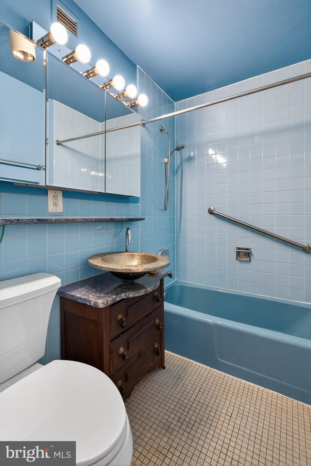 11400 Washington Plaza West, Unit 1303 Reston, VA 20190 - Photo 25 of 34 a bathroom with a sink a toilet and shower
