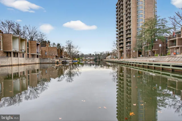 a view of a rooftop deck with lake view and lake view