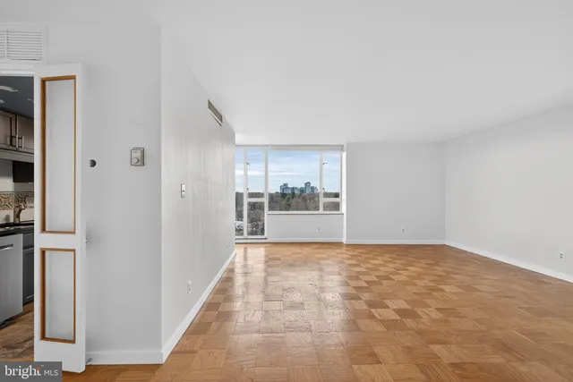 a view of an empty room with glass door