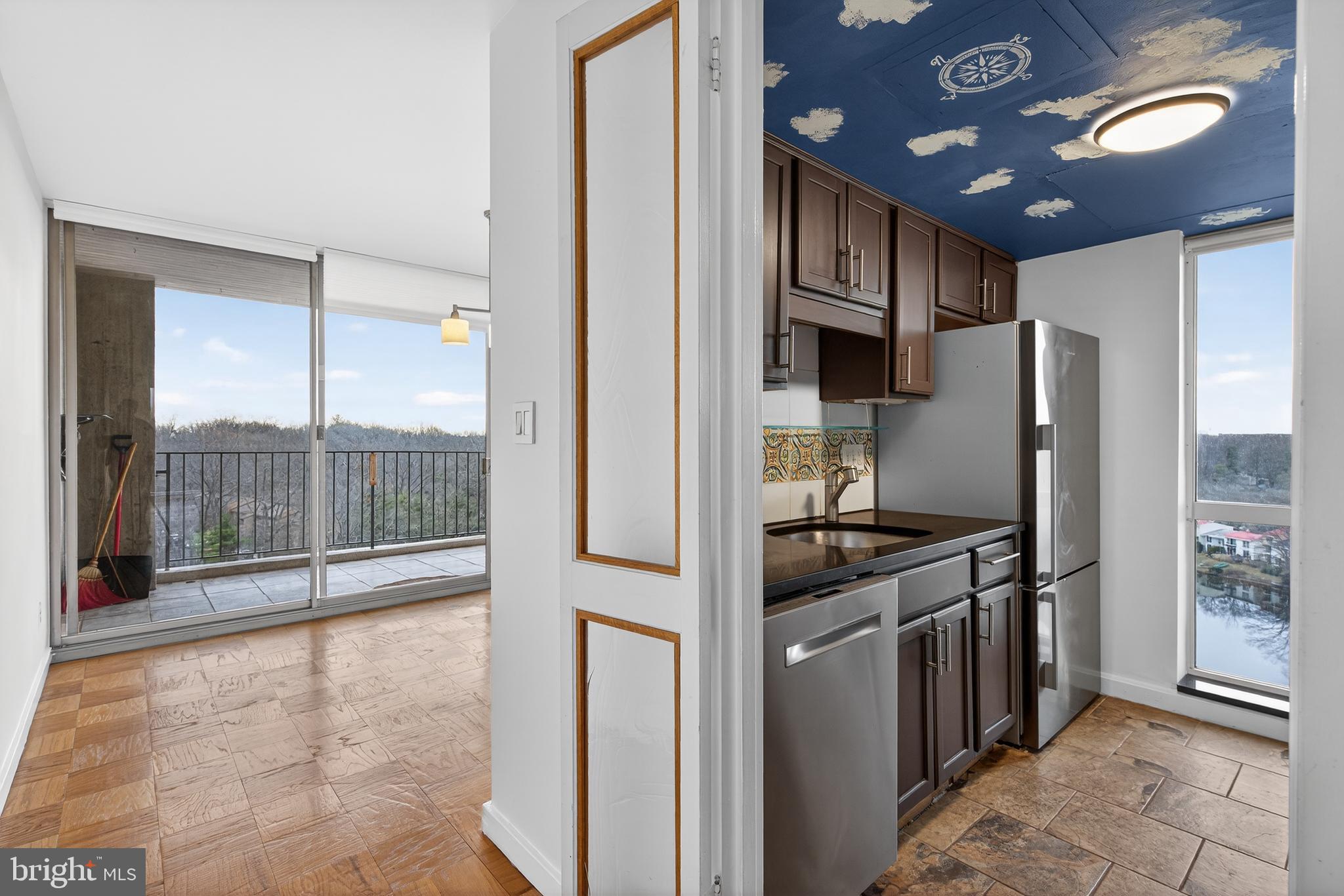 11400 Washington Plaza West, Unit 1303 Reston, VA 20190 - Photo 10 of 34 a kitchen with stainless steel appliances granite countertop a refrigerator and a sink