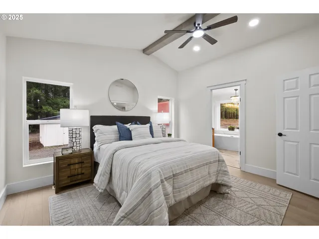 a bedroom with a bed and a ceiling fan
