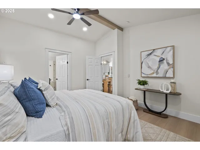 a bedroom with a bed and painting on the wall