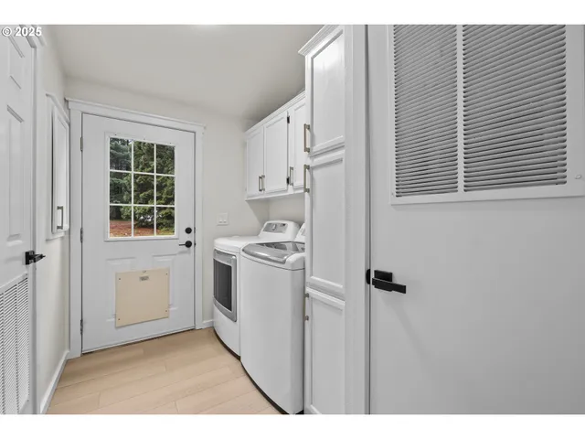 a kitchen with white cabinets and white appliances
