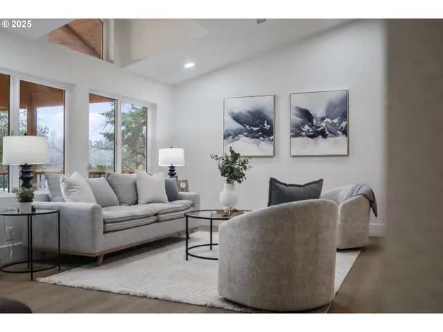 a living room with furniture and a painting on the wall