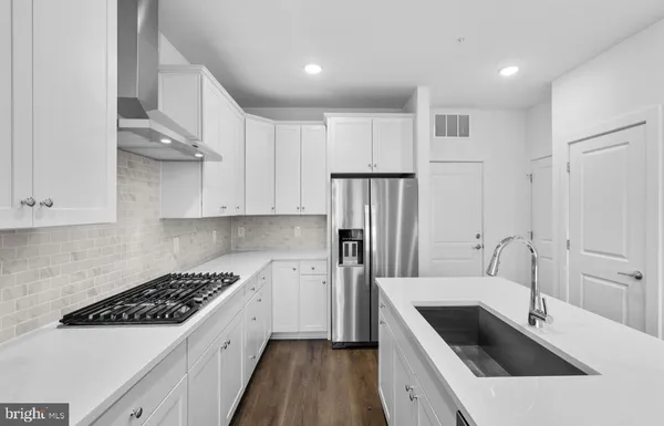 a kitchen with a sink stove and refrigerator