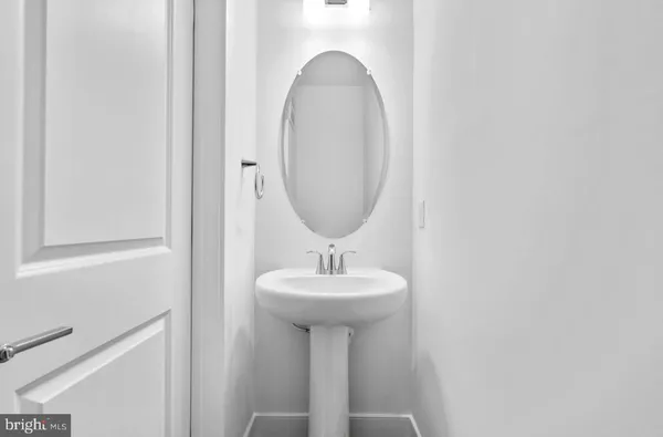 a bathroom with a sink a mirror and a toilet