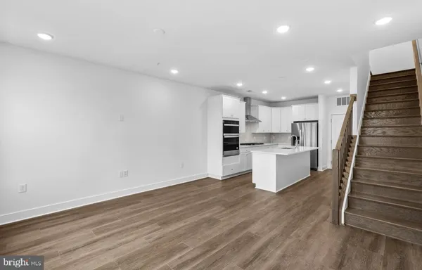 a view of kitchen with wooden floor and electronic appliances