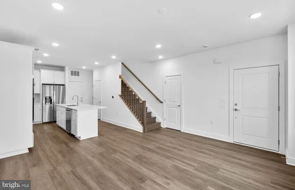 a view of a kitchen with wooden floor and stairs